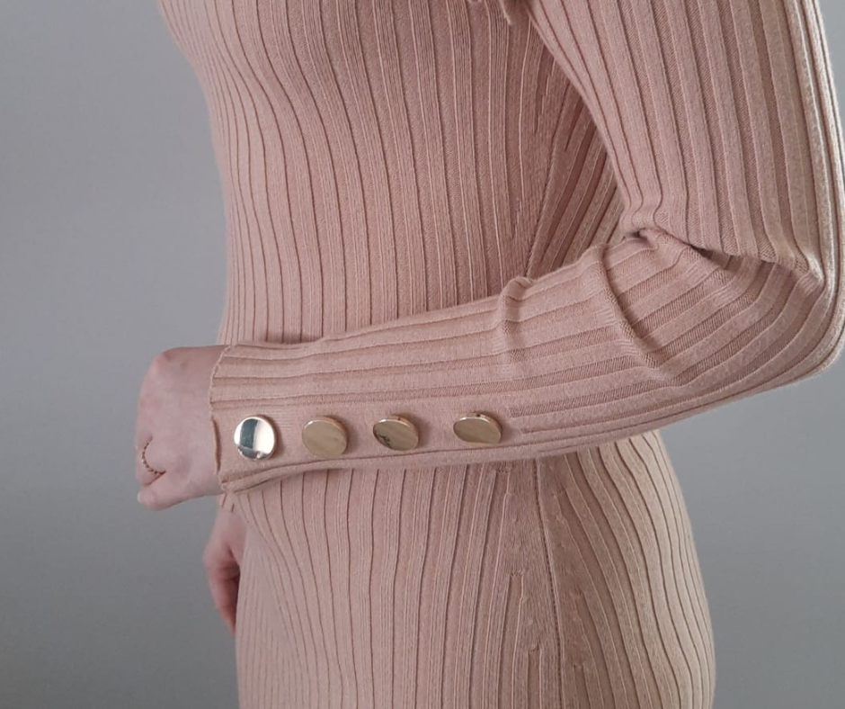 Golden buttons on the sleeve add elegance and charm